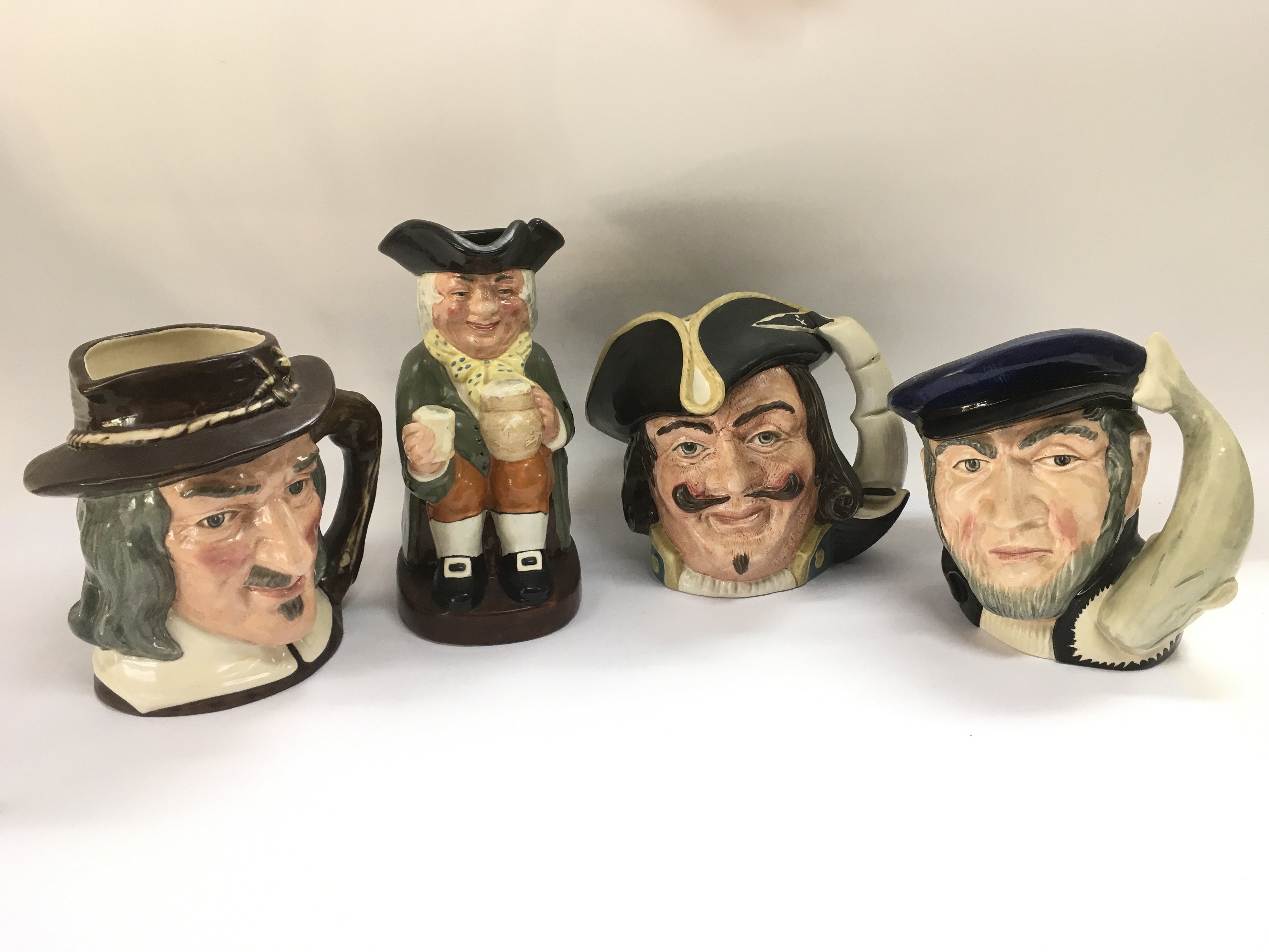 Three Royal Doulton character jugs and a Doulton T