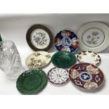 A collection of vintage ceramic plates and cut gla