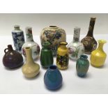 A collection of miniature oriental bud vases inclu