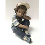 A Lladro figure of a boy titled Long Day figurine.