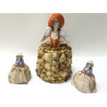 A porcelain figurine with a decorative shell skirt