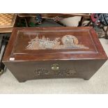 A 20thC carved oriental camphor wood chest. (Key i