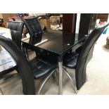 A chrome and leather modern dining table and four