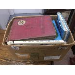 A box containing cigarette card reference books an
