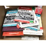 A box containing a mixture of vintage rugby and fo