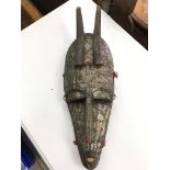 An unusual tribal mask covered in brass with attac