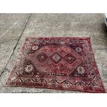 A hand woven Persian wool rug 222 x 175cm