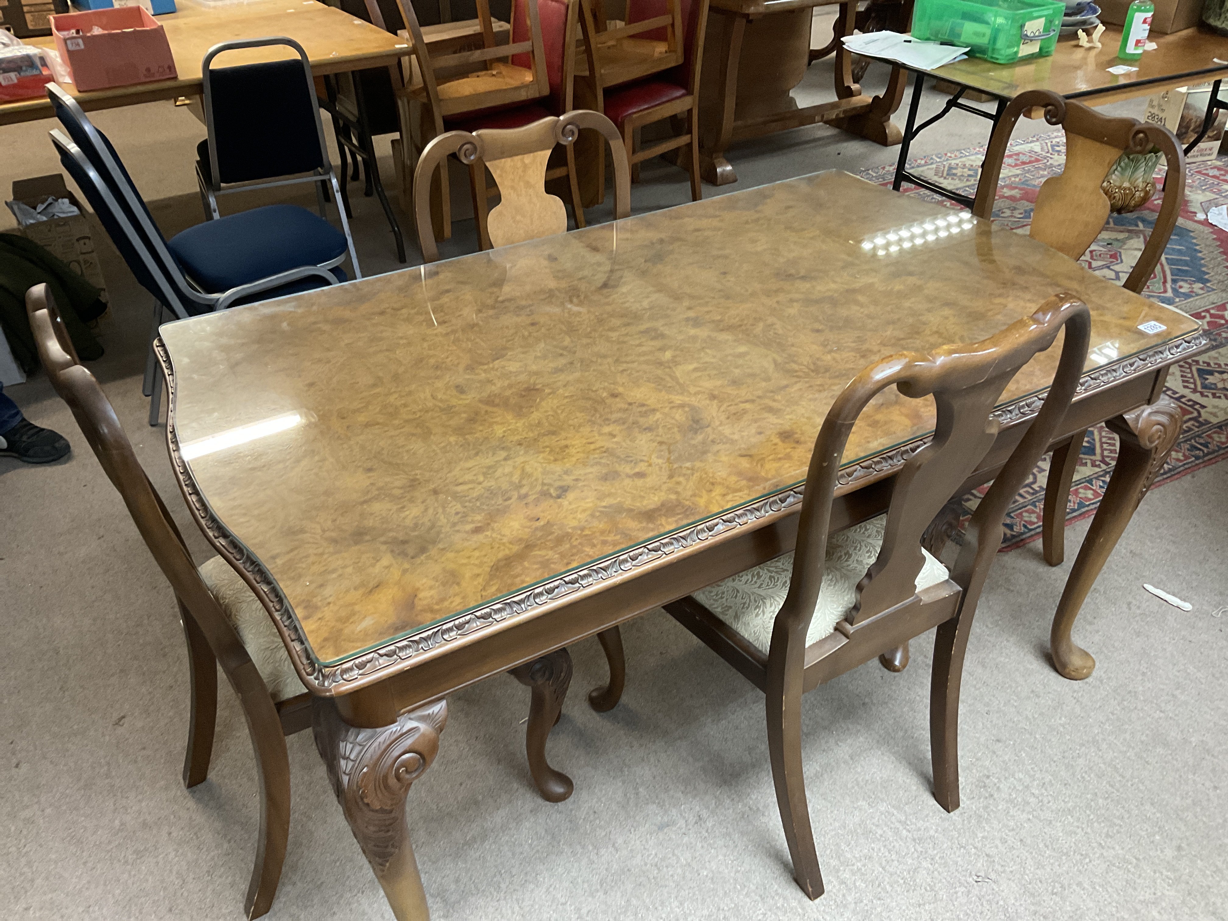 A 1920s burr walnut dining table with 4 matching d