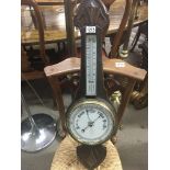 An oak barometer with thermometer box