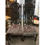 A pair of carved oak chairs with barley twist supp