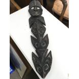 An unusual long carved tribal figure with shell ey