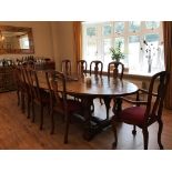 An oak and county oval top dining table on turned