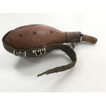 A small, possibly African, gourd liquid holder wit
