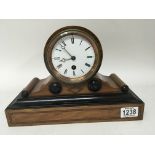 An inlaid walnut mantel clock with a white enamel