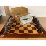 A chess set and wooden board