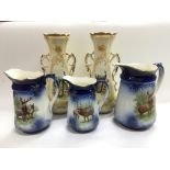 Three Victorian jugs decorated with deer together with a pair of vases depicting peacocks (5).