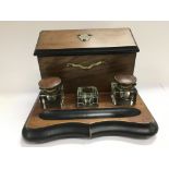 An ebonised walnut desk set.