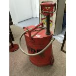 A Vintage fire extinguisher with pump handle.