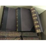 A box containing a set of half bound leather books