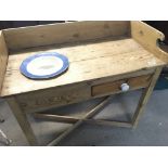 An Antique pine wash stand with a raised back abov