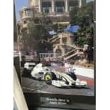 A framed Formula 1 racing car photograph signed by Jenson Button one other signed racing photo and a