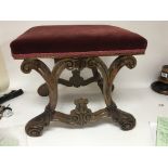 A Victorian rosewood stool with scroll supports an
