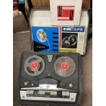 A cased travel Phillips tape recorder with tapes .