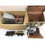 A vintage O gauge train set and a child's sewing machine (2).