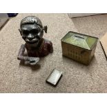 A box containing vintage money boxes, vestas and other items.