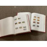 Two leather bound stamp albums including England,