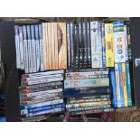 Two boxes of DVDs, blu rays and Playstation games.