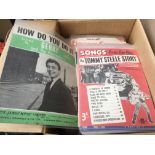 A box of vintage sheet music.