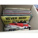 A box of LPs and 7inch singles by various artists