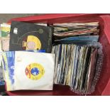 A plastic box containing 7inch singles by various