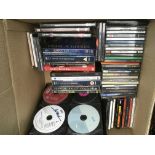 A collection of CDs and DVDs by various artists in