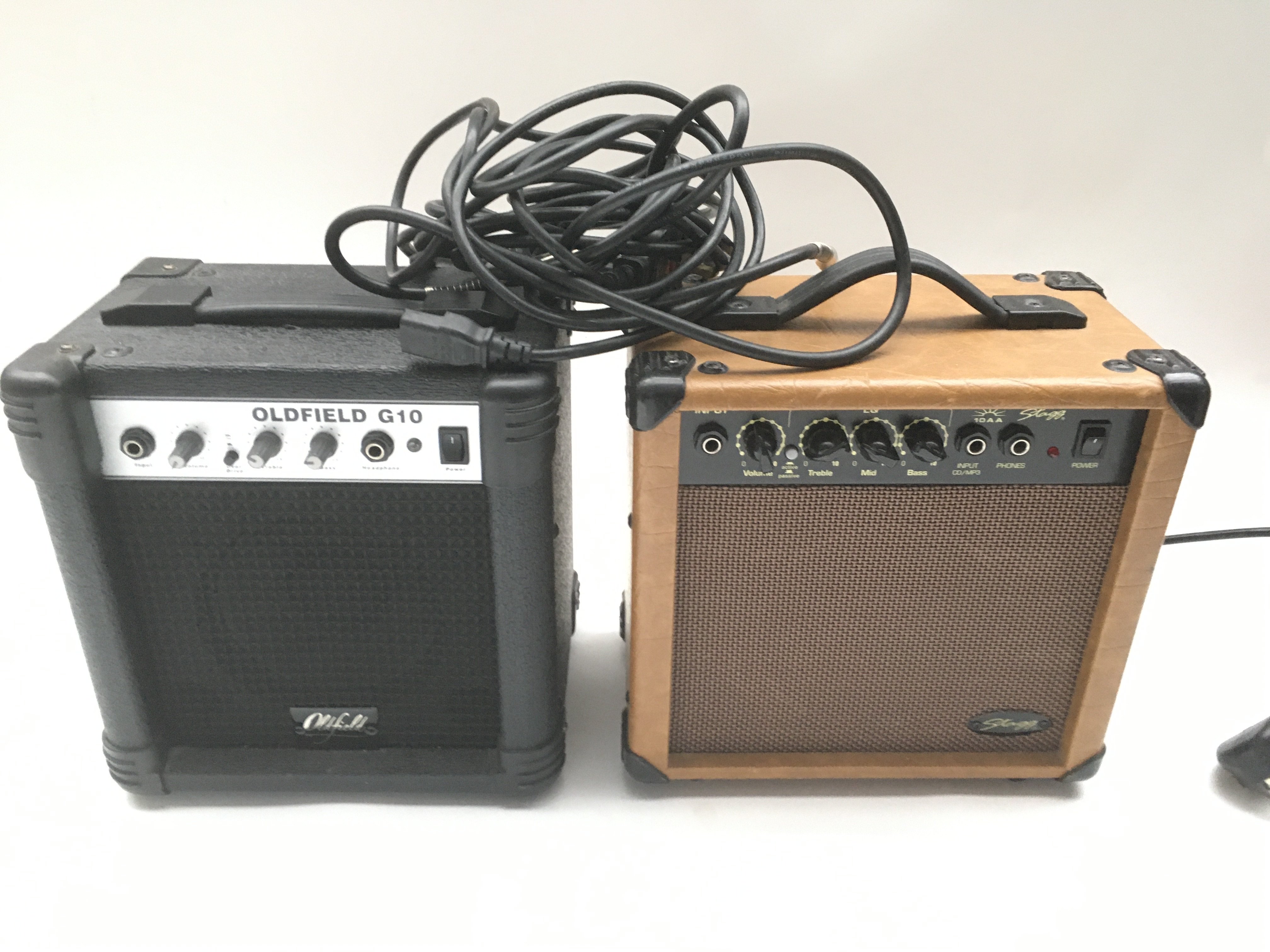 Two small practice guitar amplifiers.