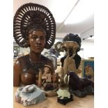 A collection of various carvings including Indonesian bust, carved figure of a geisha, goat,