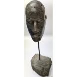 A modern handmade metal sculpture of a head on a stone base. The approximate height is 37cm.