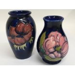 A pair of small Moorcroft vases decorated with flo