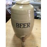 A vintage pottery beer barrel with wooden tap.