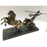 A heavy brass figure of a Roman chariot.