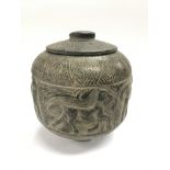 A carved antiquity in the form of a stone jar and