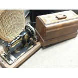 A Vintage sewing machine and a mahogany work box with contents.