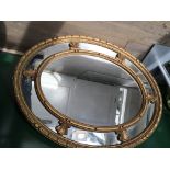 A gilt oval mirror of Edwardian style 85 cm by 75