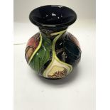 A Moorcroft vase decorated in the Queens choice pa