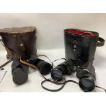 Two pairs of binoculars with leather cases.