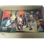 A box containing Vintage Sexton Blake Library paperback story books.