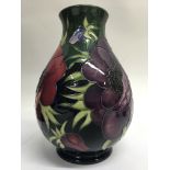 A Moorcroft vase decorated with poppies. Height 19