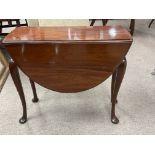 A small mahogany drop leaf table, measuring in height 50cm.