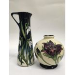 A Moorcroft jug decorated with Snowdrops together